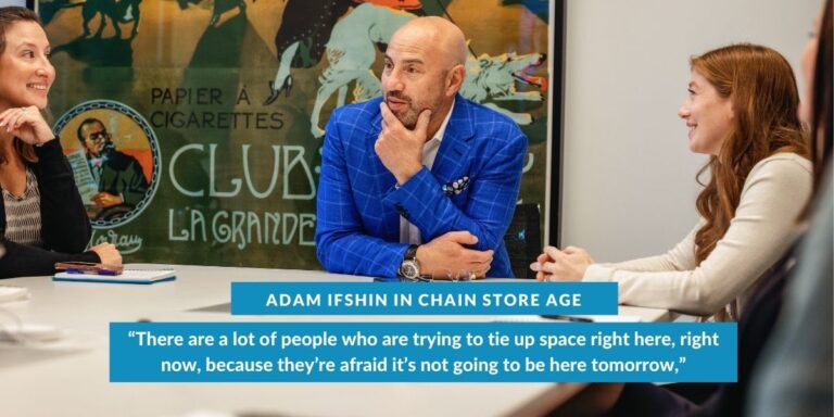 a man in a blue suit sitting at a table